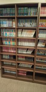a book shelf filled with lots of dvds at Hotel Matsuyama Hills in Matsuyama