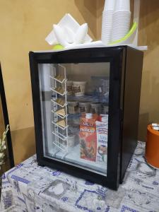 a small refrigerator filled with food on top of a table at Hotel Bonola in Milan +22 photos