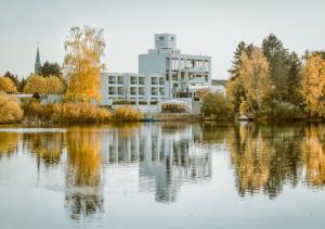 a building with its reflection in the water at Seehotel Forst in Forst