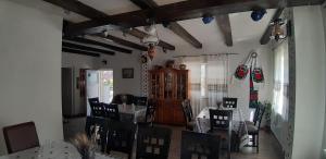a living room with a dining table and chairs at Pensiunea Casa Godja in Văleni