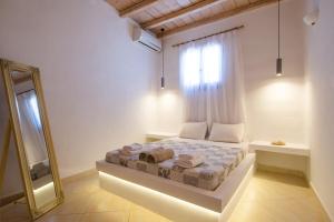 A bed or beds in a room at Natural Stone Villas