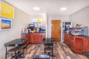 a restaurant with two tables and a counter with a kitchen at Days Inn by Wyndham Clarksville TN in Clarksville