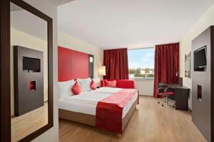 a hotel room with a bed and a window at Ramada Encore by Wyndham Geneva in Geneva +54 photos