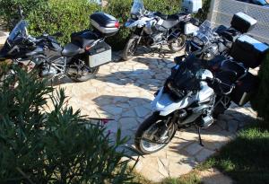 a group of motorcycles parked on a sidewalk at Helen's Sounio Apartments in Sounio
