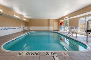 a pool in a hotel room with a no diving sign in the middle at Comfort Suites Terre Haute University Area in Terre Haute