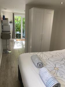 a bedroom with a white bed with a flower pattern at Brand new apartment in Knutsford in Knutsford