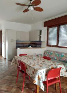 a kitchen and dining room with a table and chairs at Vacanze Porto Cesareo Salento in Torre Lapillo +21 photos