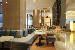 a lobby with a couch and tables at City Suites - Taipei Nandong in Taipei