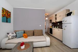 a living room with a couch and a kitchen at B Apartment in Ravni
