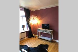 a living room with a dog laying in front of a television at Perfekter Altbaucharme in zentraler Lage ! in Kiel