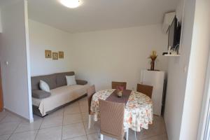 a living room with a table and a couch at Apartments Josipa in Malinska