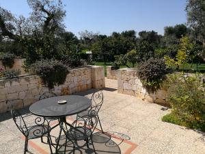 a table and chairs sitting on a patio at Masseria Asciano in Ostuni
