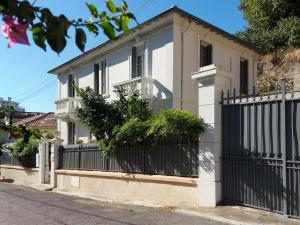 a white house with a black fence at Villa Angelus in Nice +7 photos