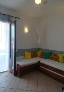 un sofá con almohadas en una habitación en Pedra do Sol Praia Estoril Sal Rei FREE WI-FI, en Sal Rei