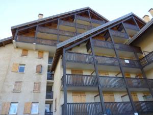 an apartment building with balconies on the side of it at SOLEIL DU SAUZE 406 in Enchastrayes