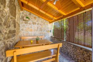 a wooden bench in a room with a stone wall at Holiday Home Vrh in Vrh