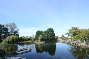 a river with a boat in the middle of it at Lakeside Old Hunstanton in Hunstanton