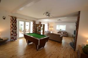 a living room with a pool table in it at Lakeside Old Hunstanton in Hunstanton