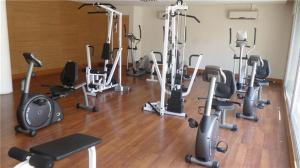 a gym with a bunch of exercise equipment on the floor at La Concepcion, Providencia Suites in Santiago
