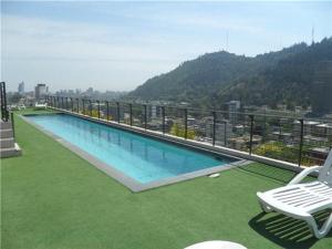 a swimming pool on the roof of a building at La Concepcion, Providencia Suites in Santiago