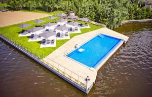 a dock with a swimming pool on the water at Selfish Club in Kiylov