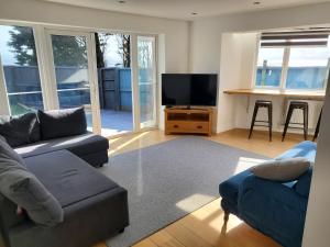 a living room with a couch and a flat screen tv at SunnyVale in Barry