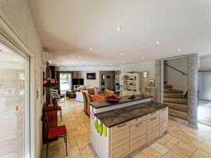 a kitchen and living room with a counter top at Villa de charme avec piscine chauffée, Jacuzzi et Sauna in Taradeau