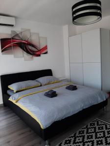a bedroom with a bed with two hats on it at White City 1 Apartment in Belgrade