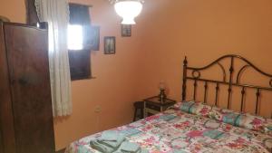 a bedroom with a bed with a quilt on it at El Soportalillo de la Fuente Vieja in Tendilla
