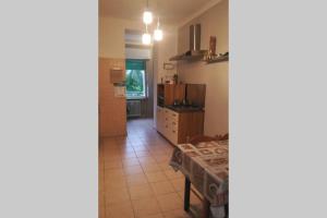 a kitchen with a table and a dining room at T Rooms - Appartamento Dafne in Casale Monferrato