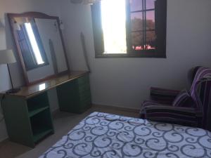 a bedroom with a mirror and a bed and a chair at Guajara loft-balcon in La Laguna +2 photos