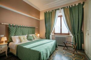 Un pat sau paturi într-o cameră la La Dimora Delle Terme
