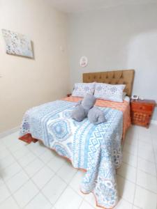 a stuffed animal is sitting on a bed at Casa Soliman - Cancun Centro Market28 Cable TV HBO FOX Netlix in Cancún