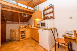a kitchen with a white refrigerator and a microwave at Panorama of Deep Blue in Tséria