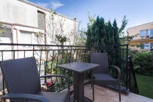 a patio with two chairs and a table on a balcony at Apartamenty Robi in Kołobrzeg