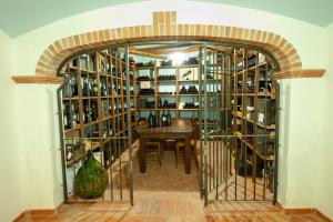 a room with a table and a wall of wine bottles at Hotel Resort Nuraghe Arvu in Cala Gonone