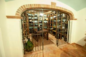 an archway in a room with a table and wine bottles at Hotel Resort Nuraghe Arvu in Cala Gonone