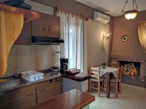a kitchen with a table and a kitchen with a dining room at Katerina Apartments in Agios Ioannis Pelio