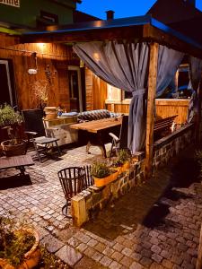 a patio with a wooden table and a blue canopy at Vintage Home 55 / Direkt am Fuße zur Wartburg in Eisenach