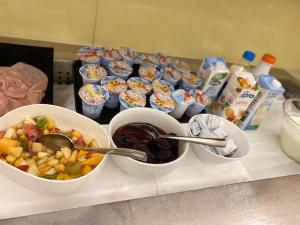 a counter with bowls of food and cups of food at Atlantic Terme Natural Spa & Hotel in Abano Terme