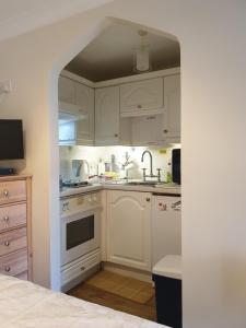 a kitchen with white cabinets and a sink at 'Mysty' Studio style Winter deal on 3 nights or more Nov to Mar in Windermere