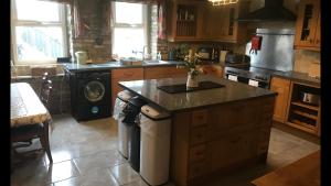 a kitchen with a stove and a counter top at Aberystwyth, Pentre Farmhouse, in Capel Bangor