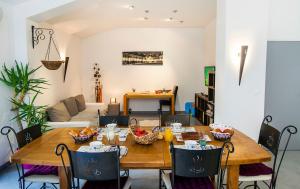 a living room with a wooden table and chairs at Le Moulin d'Harcy in Lonny