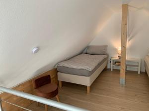 a small room with a bed in the attic at Apartment Brander Blick in Aachen