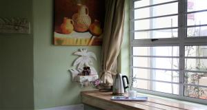 a kitchen with a window and a wooden counter top at High Palms (HPK) Guesthouse & kite school in Langebaan