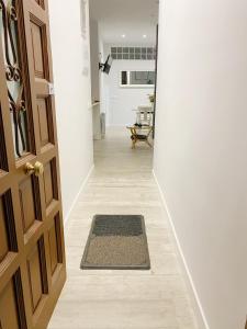 a hallway with a door and a mat on the floor at Reina Victoria 46 in Madrid