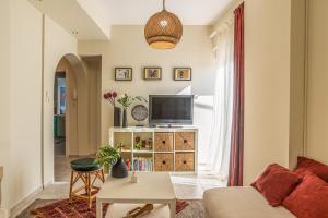a living room with a couch and a tv at Saint Minas Loft in Heraklio