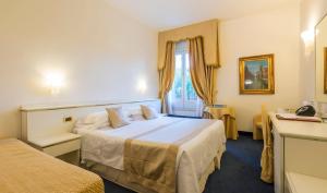 Postel nebo postele na pokoji v ubytování Hotel 4 Stagioni Sensus Spa