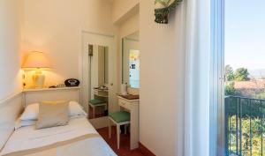 Postel nebo postele na pokoji v ubytování Hotel 4 Stagioni Sensus Spa