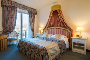Postel nebo postele na pokoji v ubytování Hotel 4 Stagioni Sensus Spa